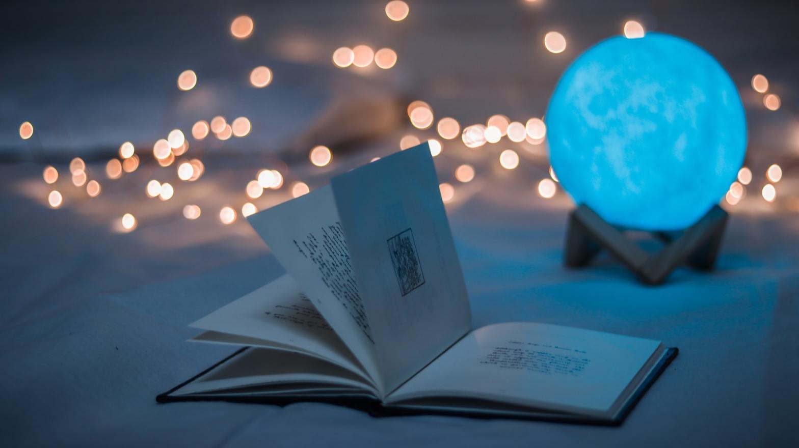 A book and a moon lamp