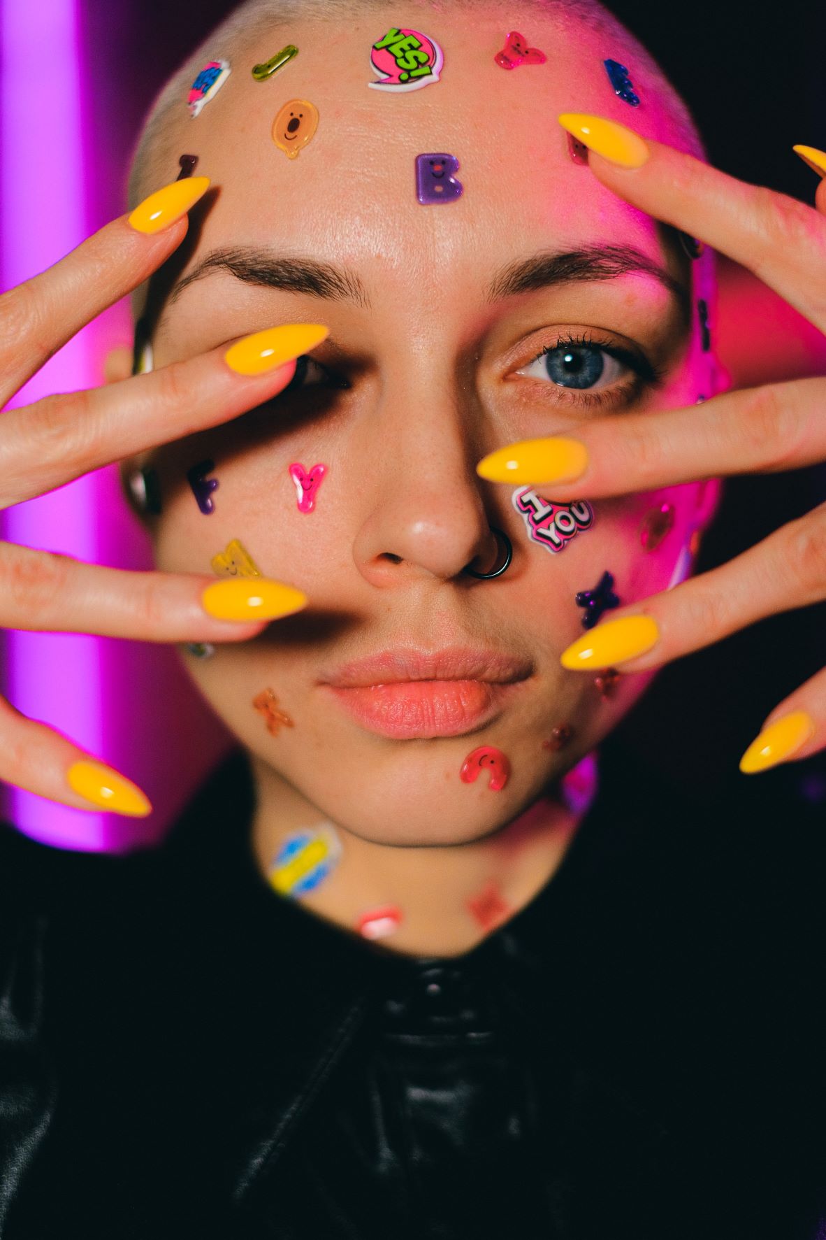 Woman with sticker signs on face.