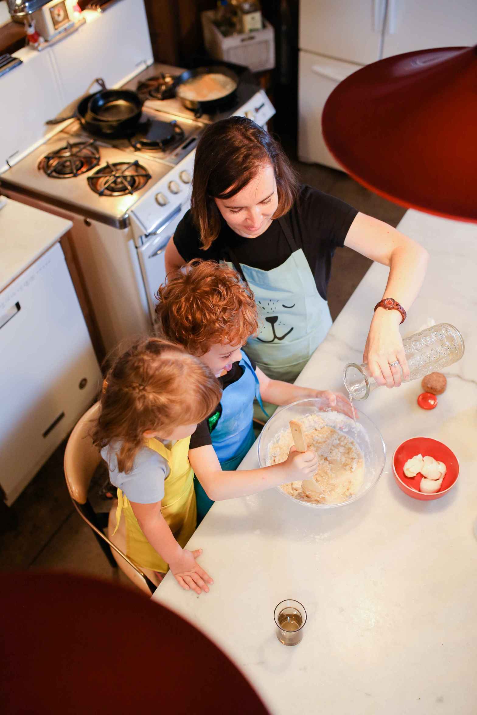 mom teaching kids how to cook