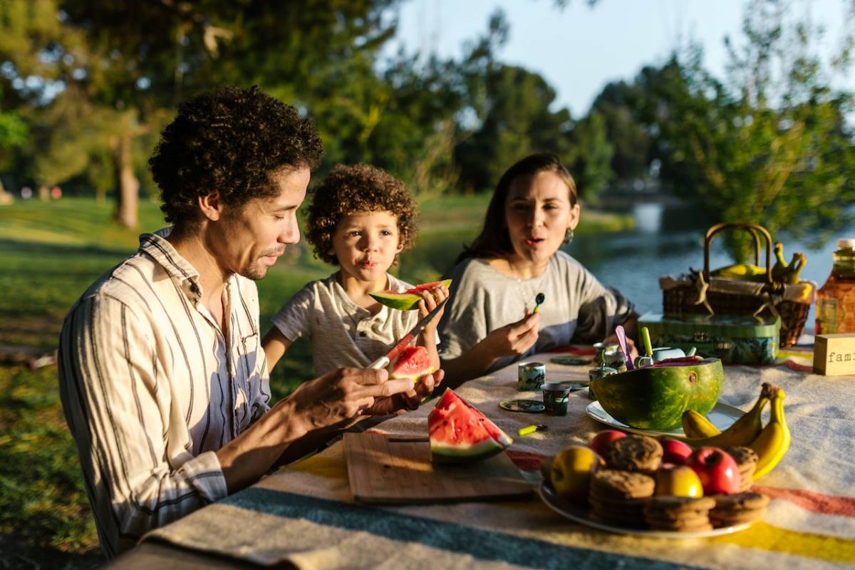 family eating watermelon outdoors how food connects us