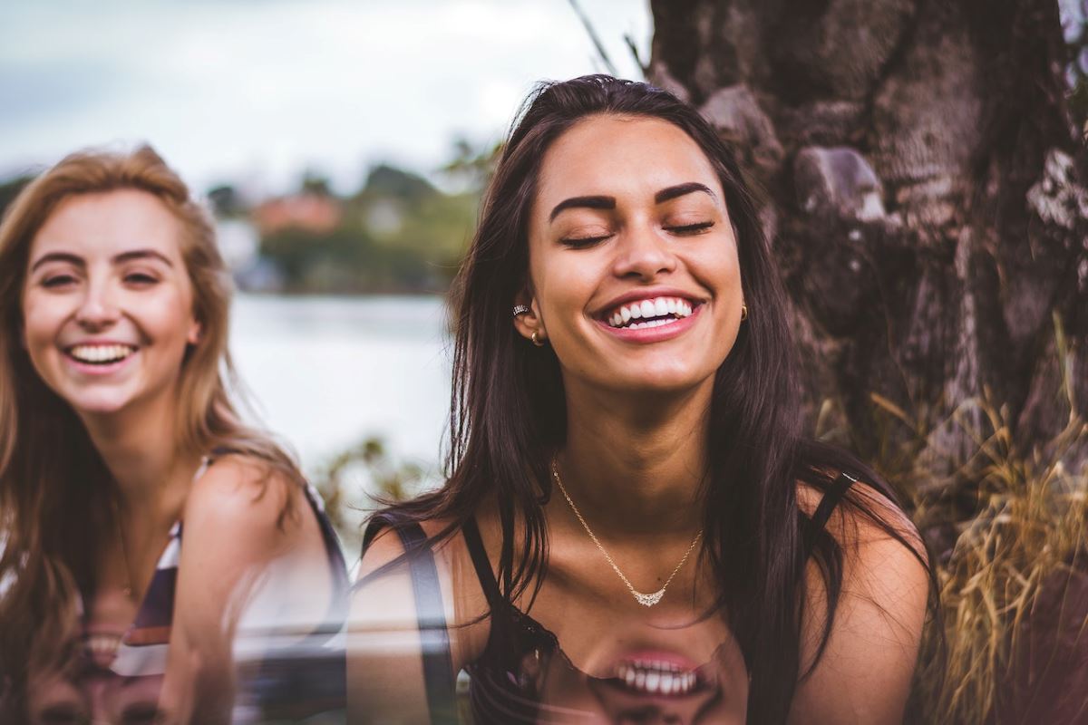 women smiling and laughing how to constantly choose happiness