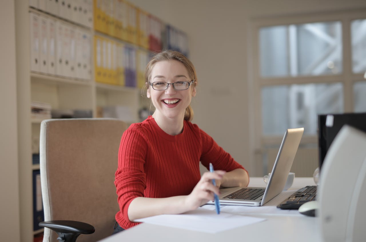 woman smiling on desk time management tips to help caregivers